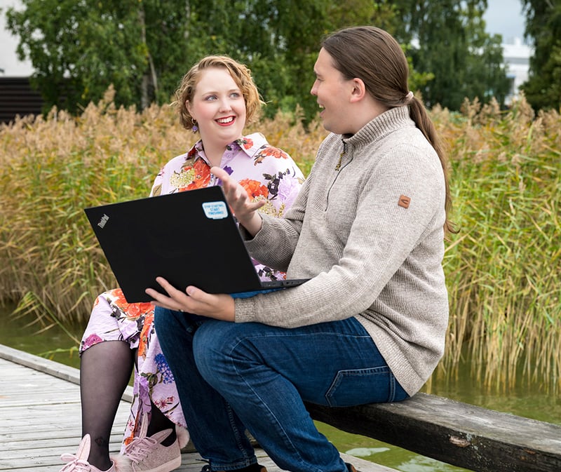KSP two people discussing outdoors espoo
