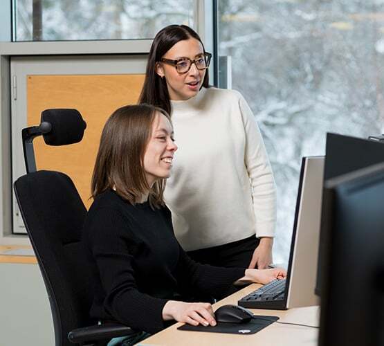 ksp-two-women-looking-at-a-computer-screen-winter-background-espoo-campus